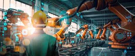 Factory Female Industrial Engineer working with Ai automation robot arm